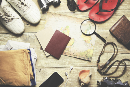 Items include,  sweater, camera, film, binoculars, passport, wallet, map,sport shoes,compassの写真素材