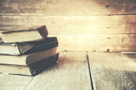 Bunch of vintage books on wooden tableの写真素材