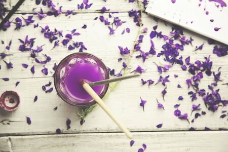 flower petals, watercolor, brush and notebook on tableの写真素材