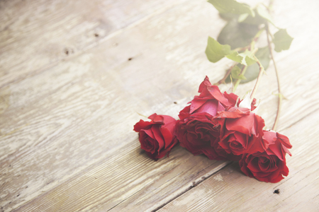 beautiful red  roses on wooden backgroundの写真素材