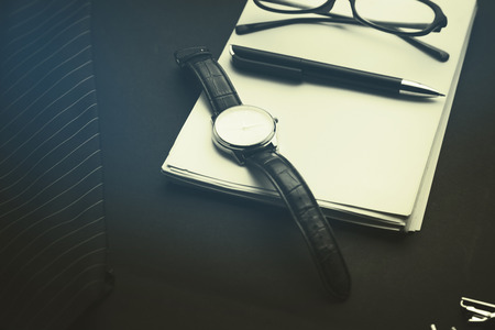 tie,notebook,glasses,watch  and coffee on  black backgroundの写真素材