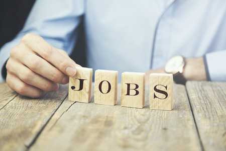 business man holding wooden cubes reading -Jobsの写真素材