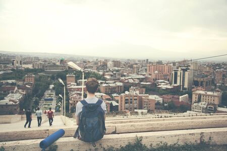 A traveler sitting watching at the city