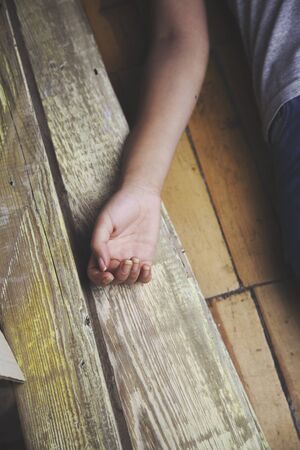 woman lying on the wooden floor. Empty roomの写真素材