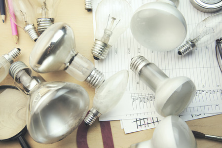 different bulbs on documents on tableの写真素材