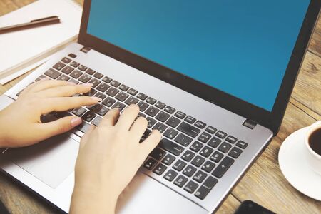 Business woman sitting in front of computer monitor and analyzing data