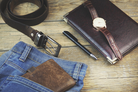 Man different elegant  accessories on wooden background