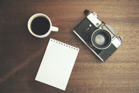 paper,coffee and camera on wooden tableの写真素材