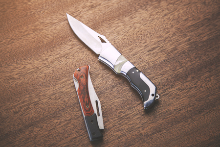 Knifes on wooden background
