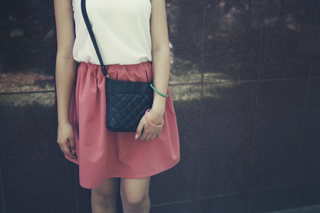 woman in trendy dress in wall backgroundの写真素材