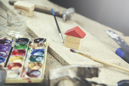 brush and wooden model of a houseの写真素材