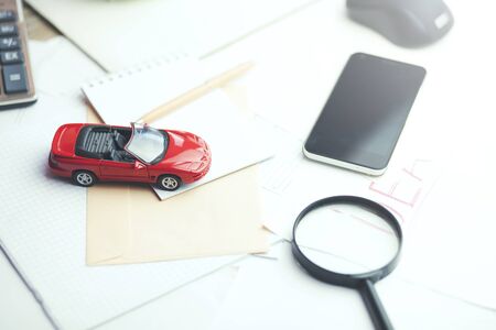 Car,magnifier,calculator  and documents,car for rentalの写真素材