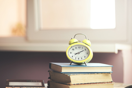 stack of books and an alarm clockの写真素材
