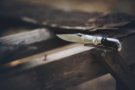 pocket knife on woodの写真素材
