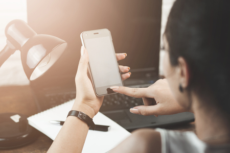 Close up of a woman using smart phoneの写真素材