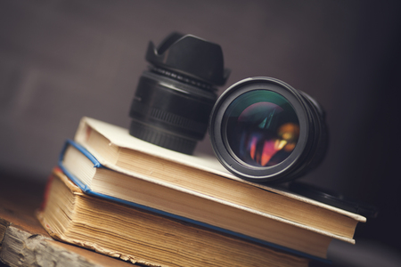 Retro camera with old book on tableの写真素材