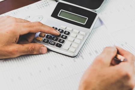 Businessman analyzing investment charts with laptop. Accounting