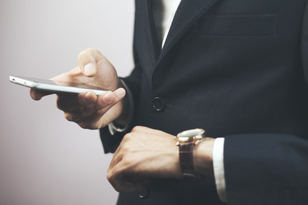 Man with Mobile phone connected to a smart watch