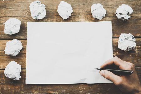Office desk table with supplies and crumpled paperの写真素材