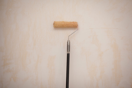Paint roller applying on white wallの写真素材