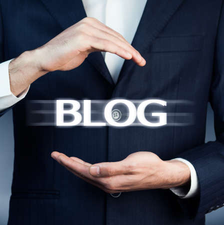 Businessman in suit with two hands in position to protect the word "BLOG"の写真素材