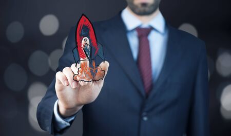 businessman touching rocketの写真素材
