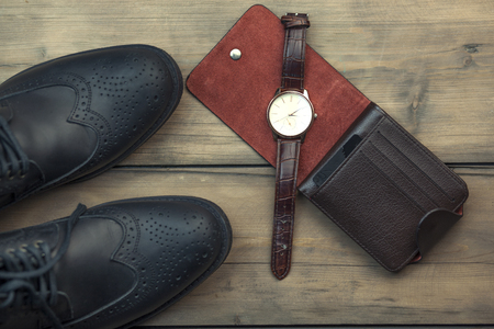 Man accessories,watch, shoes, wallet on wooden backgroundの写真素材