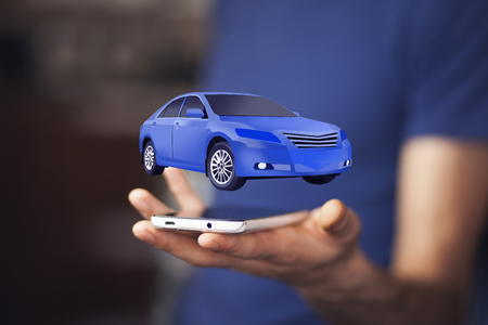 Businessman in suit holding virtual carの写真素材