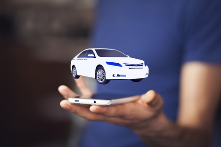 Businessman in suit holding virtual carの写真素材