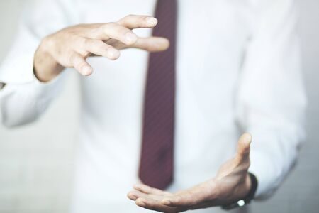 Man cupping his hands in a protective gesture