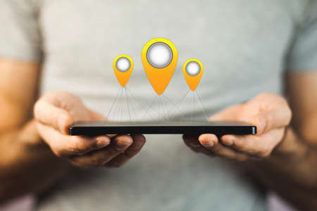 man hand tablet with  location pins.の写真素材