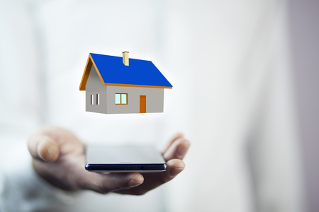 Man hand phone with  house modelの写真素材