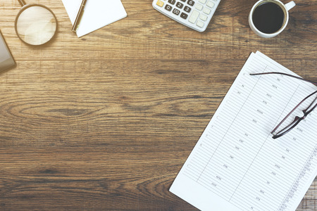 documents,calculator,coffee,magnifier,glasses and phone on tableの写真素材