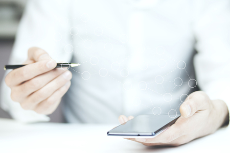 businessman holding phone and social network on white backgroundの写真素材