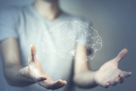 businessman with wire frame hand holding glow abstract brain structureの写真素材