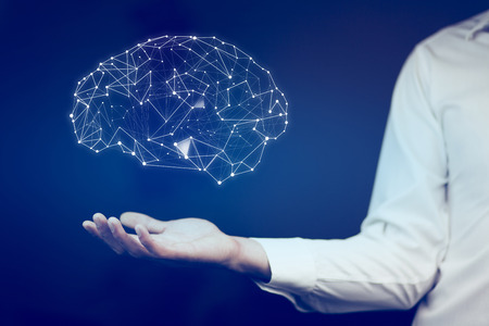 businessman with wire frame hand holding glow abstract brain structureの写真素材