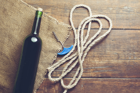 Wine  and corkscrew on the wooden background.の写真素材