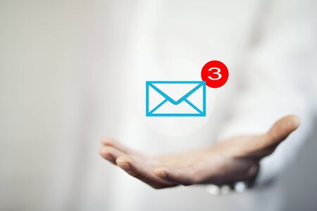 mail marketing concept with mail letter icons on hand , business concept , business ideaの写真素材