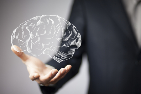 Close up of businessman hand holding brain in palmの写真素材