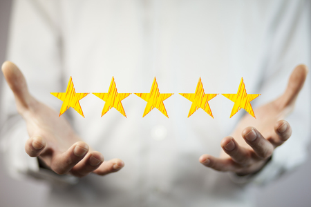 View of a Businessman touching technology interface with ranking starsの写真素材