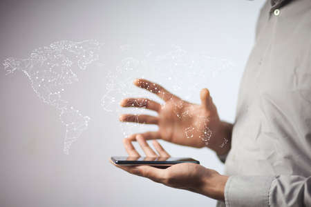 businessman hand phone with  world map on the screen
