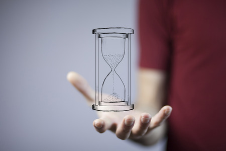 Close up of businessman holding sandglass in hand