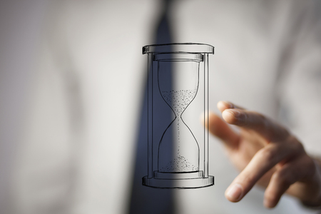 Close up of businessman holding sandglass in hand