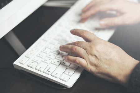  Old woman working on a keyboard computer