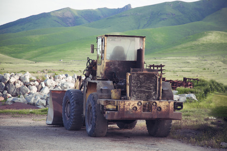Vintage dirty tractor on the field の写真素材