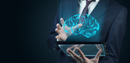 Man hand brain on screen on modern digital tabletの写真素材