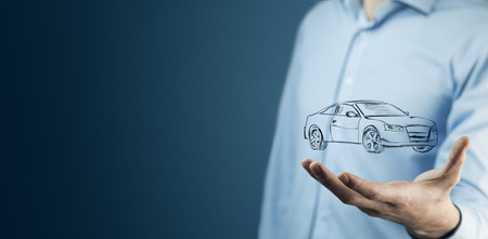 businessman hand holding car in the screen の写真素材