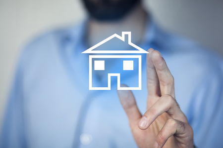 man hand blue house model  in screenの写真素材