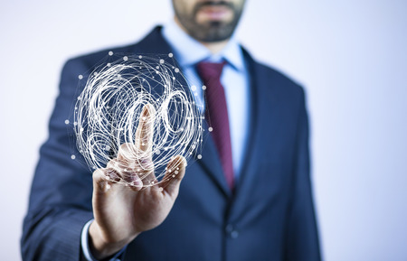 Close up to businessman standing and holding digital globe