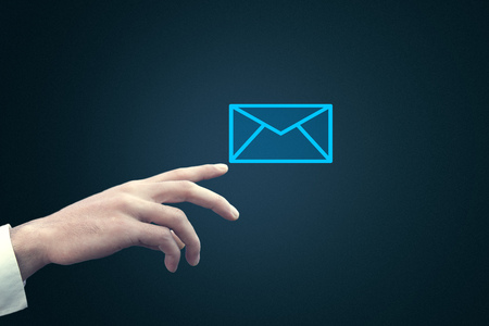 Businessman touching email icon on a virtual screenの写真素材